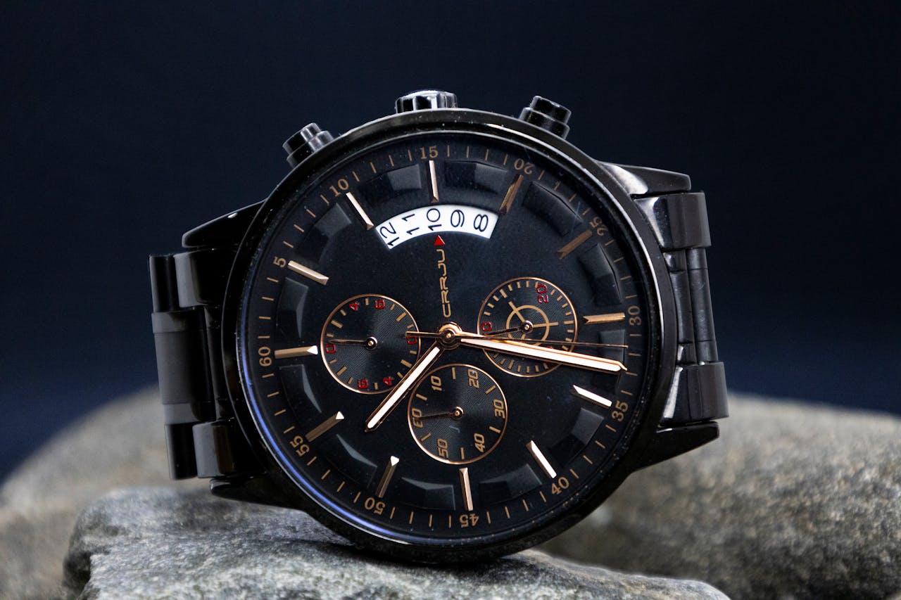menu-07 Close-up of a stylish black chronograph wristwatch showcasing its intricate dial design.
