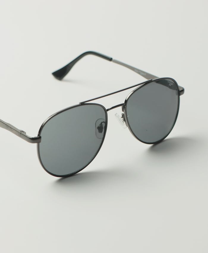 Stylish black aviator sunglasses with dark lenses on a white background, perfect for fashion collections.